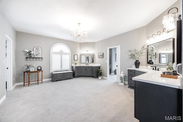 9 Shellie Ct, Fairview Heights, IL 62208 - bathroom with a chandelier, baseboards, two vanities, and tile patterned floors