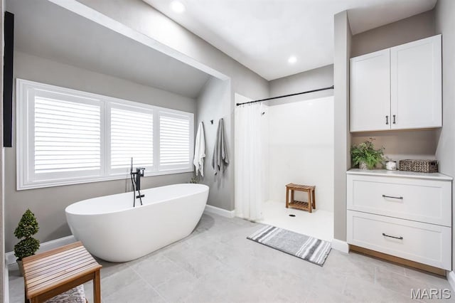 9 Shellie Ct, Fairview Heights, IL 62208 - bathroom featuring curtained shower, a freestanding bath, and baseboards