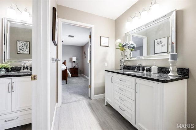 9 Shellie Ct, Fairview Heights, IL 62208 - ensuite bathroom with wood finished floors, two vanities, and baseboards