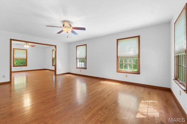 3743 Rock Creek Valley Rd, High Ridge, MO 63049 - spare room featuring healthy amount of natural light, wood finished floors, ceiling fan, and baseboards