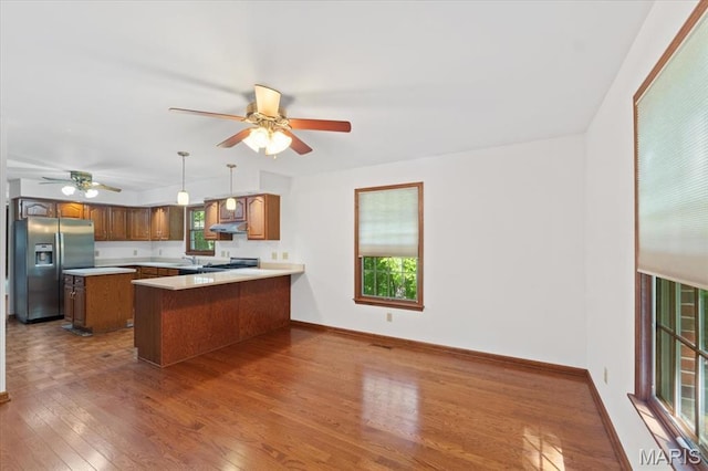 3743 Rock Creek Valley Rd, High Ridge, MO 63049 - kitchen featuring stainless steel refrigerator with ice dispenser, under cabinet range hood, a ceiling fan, wood finished floors, and range