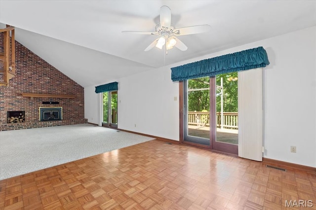 3743 Rock Creek Valley Rd, High Ridge, MO 63049 - unfurnished living room featuring baseboards, a ceiling fan, a brick fireplace, lofted ceiling, and brick wall