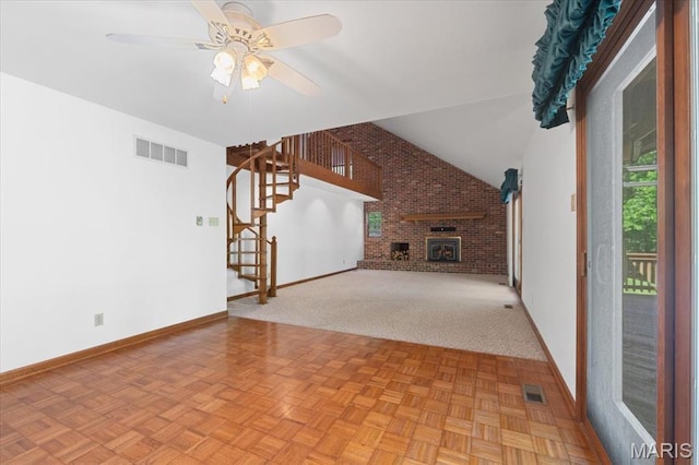 3743 Rock Creek Valley Rd, High Ridge, MO 63049 - unfurnished living room featuring stairs, brick wall, baseboards, a ceiling fan, and vaulted ceiling