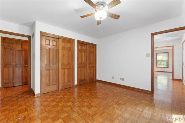 3743 Rock Creek Valley Rd, High Ridge, MO 63049 - unfurnished bedroom with baseboards, two closets, and a ceiling fan