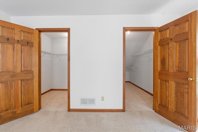 3743 Rock Creek Valley Rd, High Ridge, MO 63049 - unfurnished bedroom with a walk in closet, carpet floors, a closet, and lofted ceiling