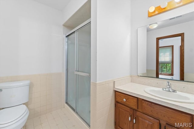 3743 Rock Creek Valley Rd, High Ridge, MO 63049 - bathroom with tile walls, toilet, vanity, a shower stall, and a wainscoted wall