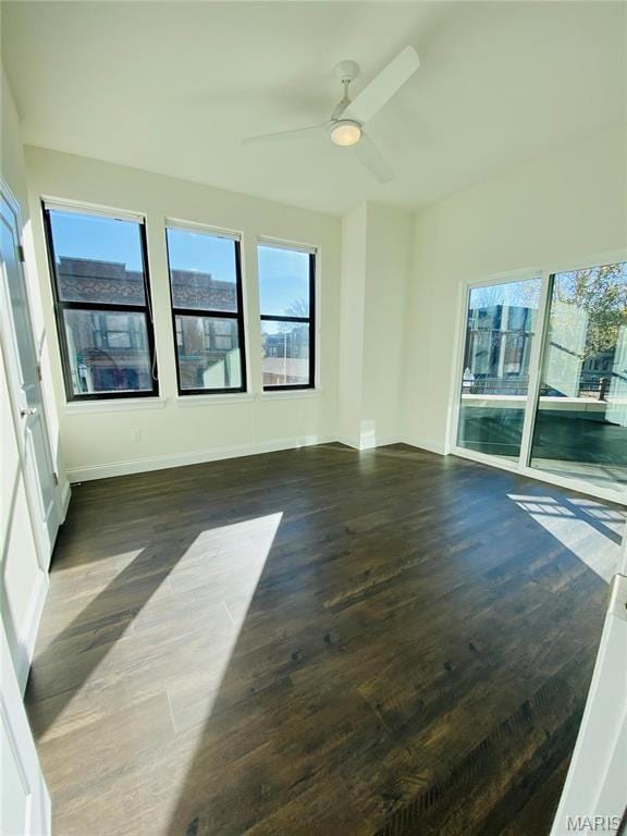 4301 Maryland Ave Unit 2, Saint Louis, MO 63108 - spare room with dark wood-type flooring, a ceiling fan, and baseboards