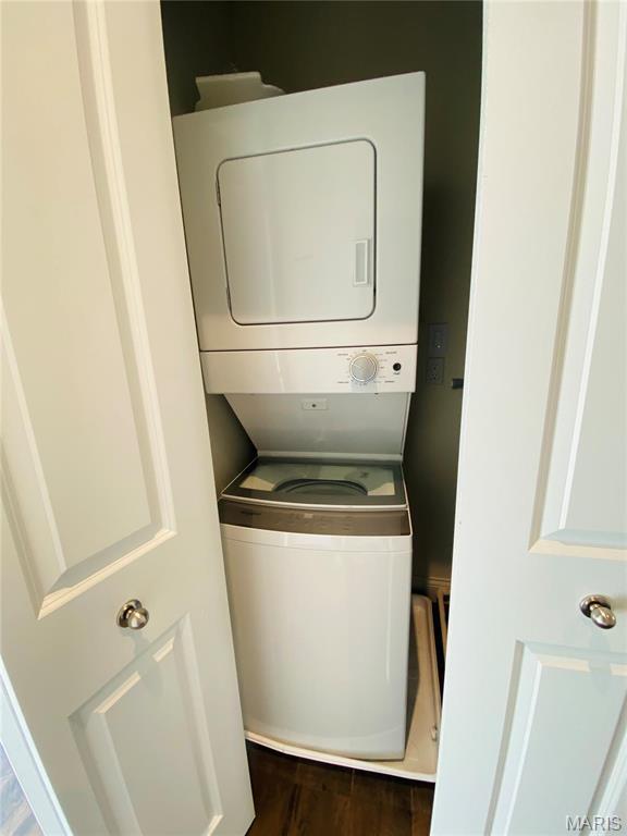 4301 Maryland Ave Unit 2, Saint Louis, MO 63108 - laundry room featuring stacked washer / drying machine and dark wood-style floors