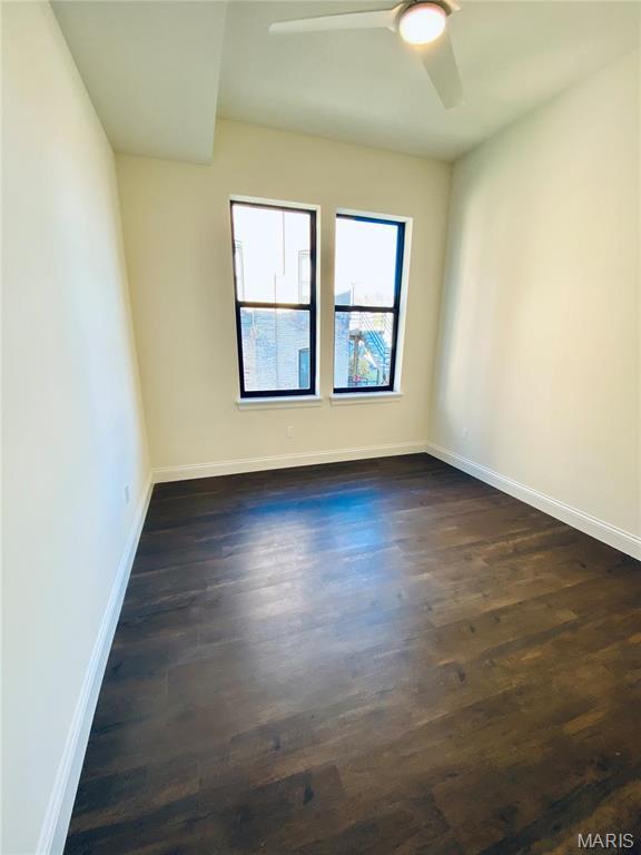 4301 Maryland Ave Unit 2, Saint Louis, MO 63108 - unfurnished room with baseboards, a ceiling fan, and dark wood-type flooring