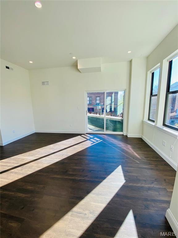 4301 Maryland Ave Unit 2, Saint Louis, MO 63108 - spare room with wood finished floors, baseboards, and recessed lighting