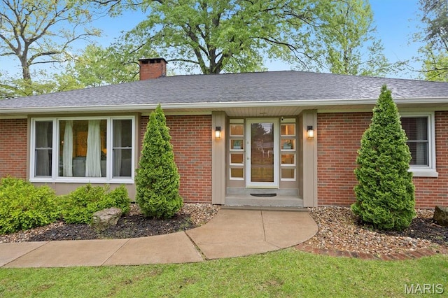 350 Barnett Dr, Edwardsville, IL 62025 - entrance to property with a chimney and brick siding