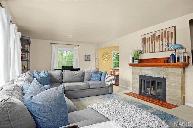 350 Barnett Dr, Edwardsville, IL 62025 - living area featuring carpet, a stone fireplace, and baseboards