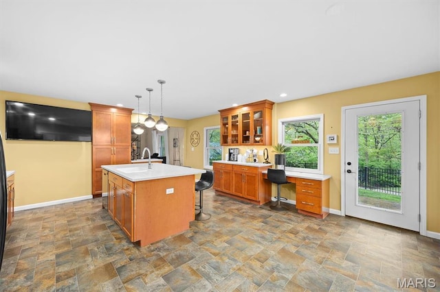 350 Barnett Dr, Edwardsville, IL 62025 - kitchen with dark stone finish floors, brown cabinetry, baseboards, light countertops, and recessed lighting
