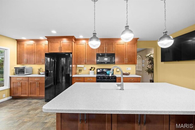 350 Barnett Dr, Edwardsville, IL 62025 - kitchen with black appliances, light countertops, hanging light fixtures, stone finish floors, and recessed lighting