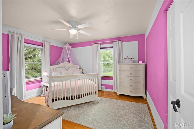 350 Barnett Dr, Edwardsville, IL 62025 - bedroom featuring multiple windows, wood finished floors, and baseboards