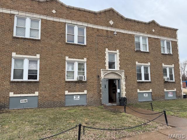 3936 Cook Ave, Saint Louis, MO 63113 - view of front of house with brick siding, a front yard, and cooling unit