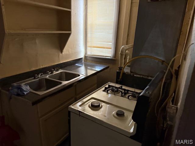 3936 Cook Ave, Saint Louis, MO 63113 - kitchen with a sink, white gas range oven, dark countertops, and open shelves