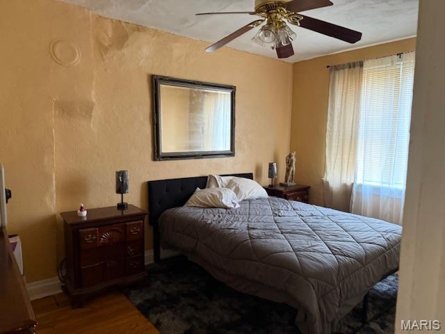 3936 Cook Ave, Saint Louis, MO 63113 - bedroom with wood finished floors, baseboards, and a ceiling fan