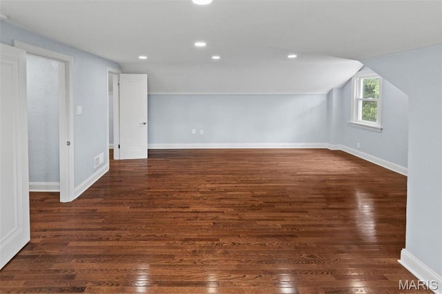 additional living space featuring wood finished floors, recessed lighting, baseboards, and vaulted ceiling