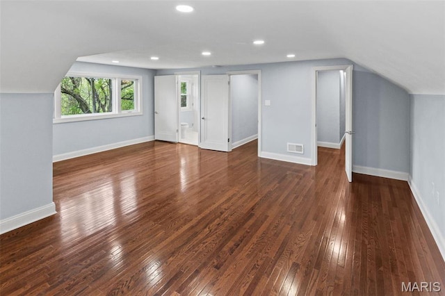 additional living space with dark wood finished floors, vaulted ceiling, recessed lighting, and baseboards