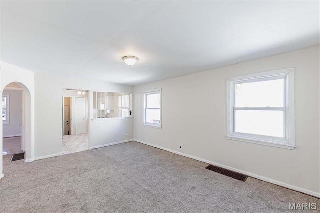 7150 Beulah Ave, Saint Louis, MO 63136 - empty room featuring carpet, arched walkways, and baseboards