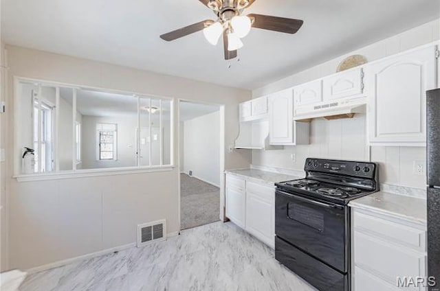 7150 Beulah Ave, Saint Louis, MO 63136 - kitchen featuring black electric range oven, under cabinet range hood, and white cabinetry