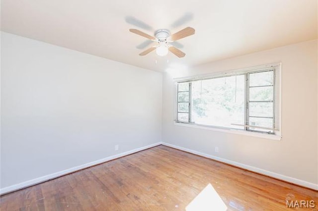 7150 Beulah Ave, Saint Louis, MO 63136 - unfurnished room with baseboards, a ceiling fan, and wood finished floors