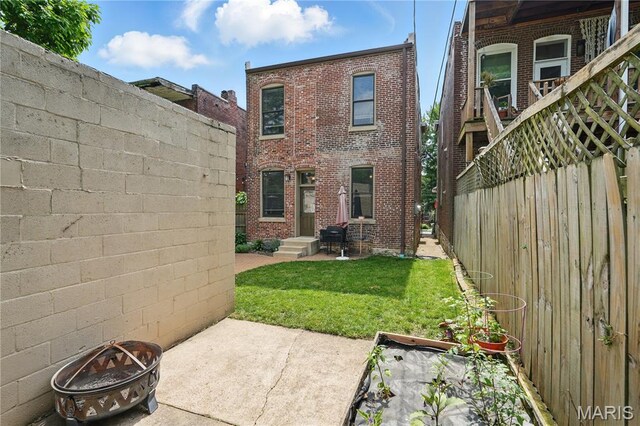3015 Indiana Ave, Saint Louis, MO 63118 - rear view of property with a fire pit, brick siding, and a patio