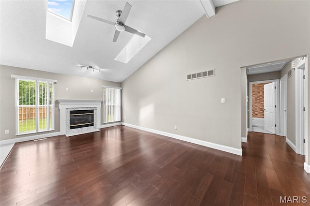 2713 Chapel View Dr, Florissant, MO 63031 - unfurnished living room with a skylight, a ceiling fan, high vaulted ceiling, dark wood-style flooring, and baseboards