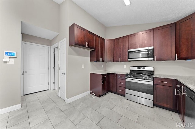 2713 Chapel View Dr, Florissant, MO 63031 - kitchen with stainless steel appliances, baseboards, light tile patterned floors, light stone countertops, and a textured ceiling