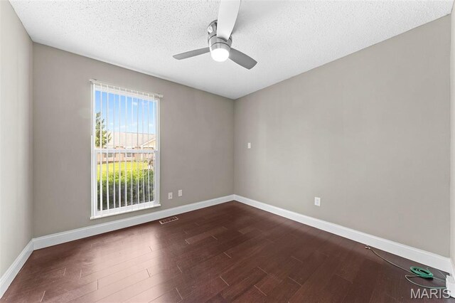 2713 Chapel View Dr, Florissant, MO 63031 - spare room with dark wood-style floors, ceiling fan, a textured ceiling, and baseboards