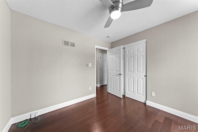2713 Chapel View Dr, Florissant, MO 63031 - unfurnished bedroom featuring baseboards, wood finished floors, a textured ceiling, a closet, and ceiling fan