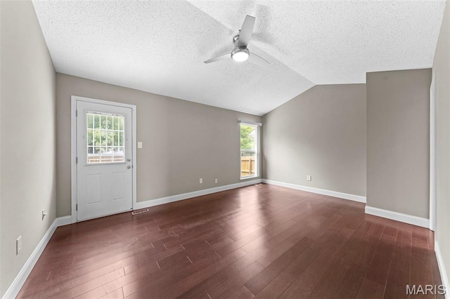 2713 Chapel View Dr, Florissant, MO 63031 - empty room with a ceiling fan, a textured ceiling, healthy amount of natural light, dark wood-style floors, and lofted ceiling