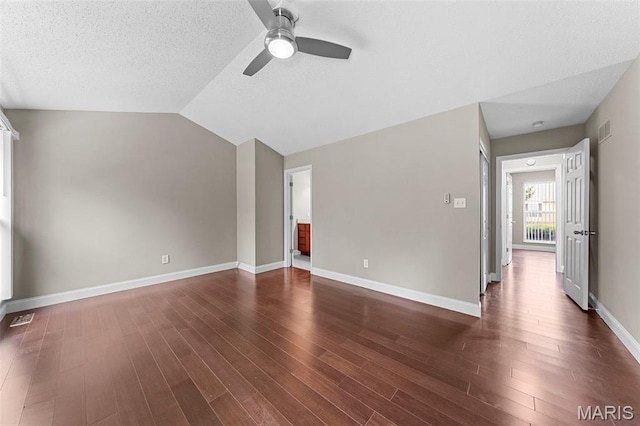 2713 Chapel View Dr, Florissant, MO 63031 - unfurnished living room featuring ceiling fan, dark wood-type flooring, baseboards, lofted ceiling, and a textured ceiling