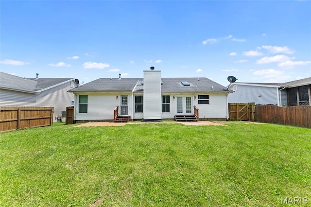 2713 Chapel View Dr, Florissant, MO 63031 - back of property with entry steps, a chimney, and french doors