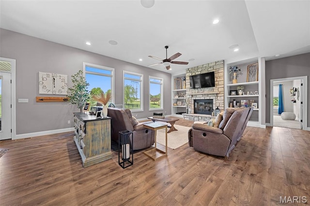 111 Foristell Ridge Ct, Foristell, MO 63348 - living room featuring a ceiling fan, wood finished floors, a fireplace, baseboards, and built in shelves
