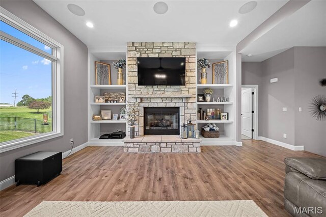 111 Foristell Ridge Ct, Foristell, MO 63348 - unfurnished living room featuring wood finished floors, baseboards, and a fireplace