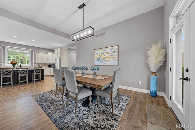 111 Foristell Ridge Ct, Foristell, MO 63348 - dining area with light wood-type flooring, recessed lighting, baseboards, and a chandelier