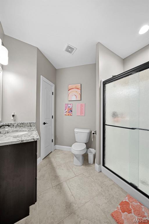 111 Foristell Ridge Ct, Foristell, MO 63348 - full bath with a shower stall, baseboards, toilet, vanity, and tile patterned floors
