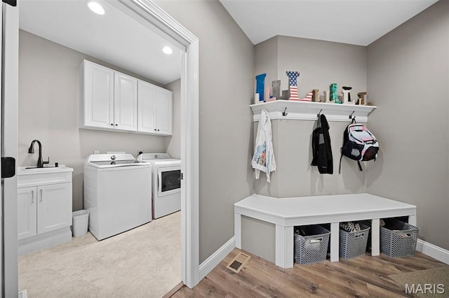 111 Foristell Ridge Ct, Foristell, MO 63348 - laundry room with washer and dryer, cabinet space, baseboards, light wood-type flooring, and recessed lighting