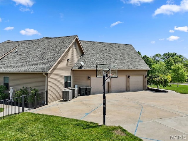111 Foristell Ridge Ct, Foristell, MO 63348 - rear view of property featuring driveway, an attached garage, cooling unit, and a shingled roof