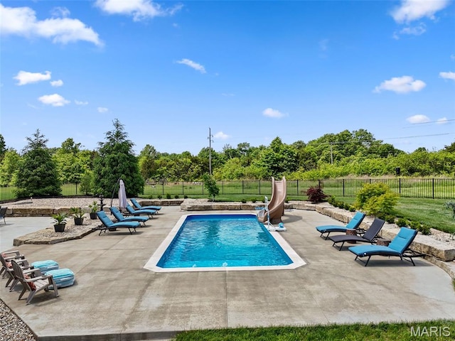 111 Foristell Ridge Ct, Foristell, MO 63348 - view of swimming pool with a patio area, a water slide, a fenced backyard, and view of wooded area