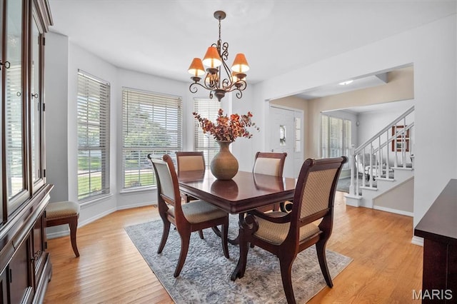 300 Wildberry Ln, Saint Charles, MO 63304 - dining area featuring a chandelier, light wood finished floors, and stairway