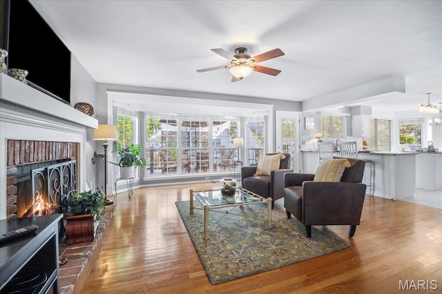 300 Wildberry Ln, Saint Charles, MO 63304 - living area featuring ceiling fan, wood finished floors, and a fireplace