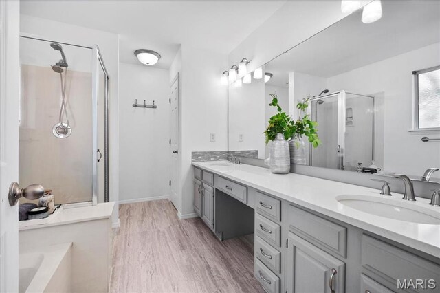 300 Wildberry Ln, Saint Charles, MO 63304 - full bathroom with a shower stall, double vanity, a bath, and wood finished floors
