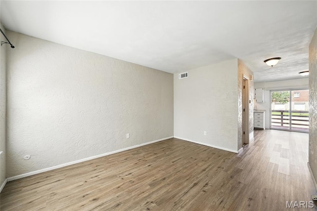 10161 Squire Meadows Drive E, Saint Louis, MO 63123 - spare room with wood finished floors and a textured wall
