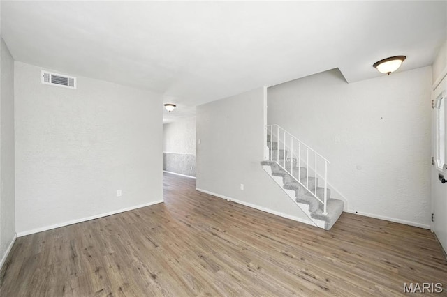10161 Squire Meadows Drive E, Saint Louis, MO 63123 - unfurnished living room with wood finished floors and stairs