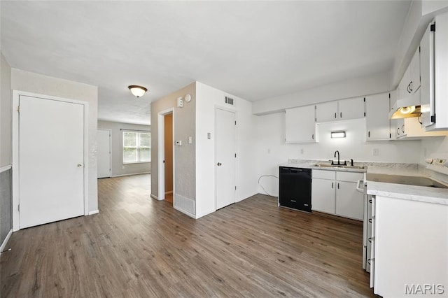 10161 Squire Meadows Drive E, Saint Louis, MO 63123 - kitchen with black dishwasher, dark wood-type flooring, light countertops, white cabinets, and under cabinet range hood