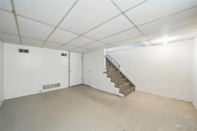 10161 Squire Meadows Drive E, Saint Louis, MO 63123 - finished basement with a paneled ceiling, stairway, and a textured wall