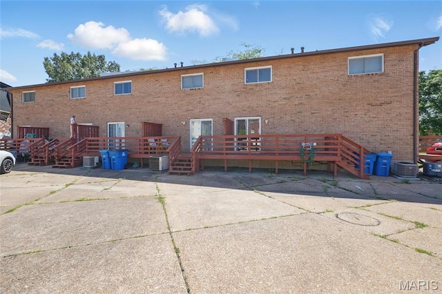 10161 Squire Meadows Drive E, Saint Louis, MO 63123 - back of house with a wooden deck and brick siding